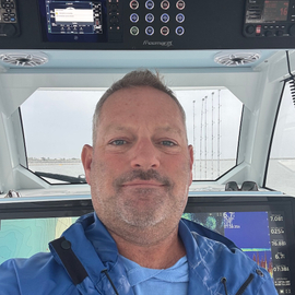Gino Raymond DellaCava at the helm